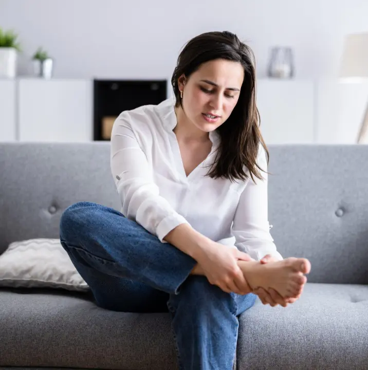 Person experiencing heel pain caused by plantar fasciitis